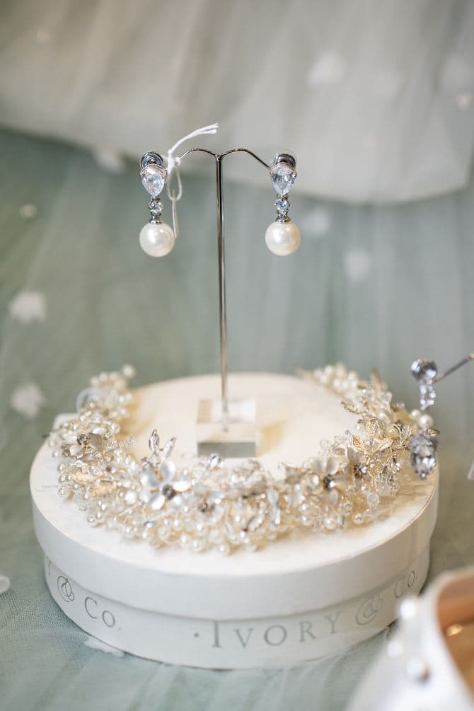 Close-up of bridal headband and pearl earrings.