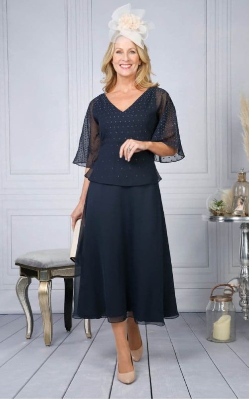 Model wearing Richard Designs 1114 occasion dress in navy.