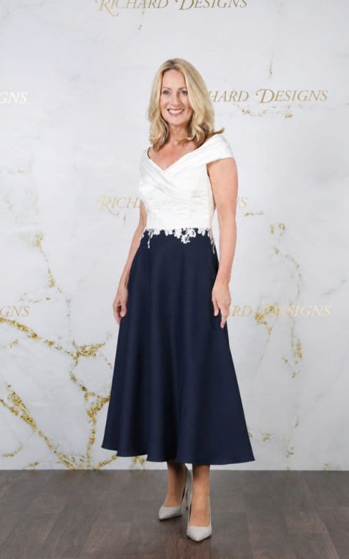 Model wearing Richard Designs 1168 occasion dress in Ivory/Navy.
