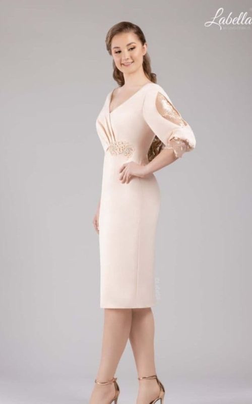 Model in rose gold occasion dress by Gino Cerruti.
